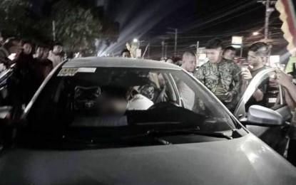 <p><strong>GUN ATTACK</strong>. Police investigators do a post-crime analysis at the scene after Sulaiman Macabangon, 50, a political officer of the BARMM parliament, was shot dead by motorcycle riding-in-tandem gunmen in Cotabato City on Tuesday night (Jan. 24, 2024). The victim was inside his car waiting for his wife to come from a mall when attacked. <em>(Photo courtesy of DXMS Radio-Cotabato)</em></p>