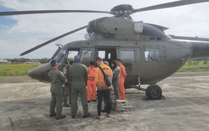 <p><strong>GEARING UP.</strong> A Philippine Air Force crew readies their Sokol 925 helicopter and rescue gear before taking off from Antonio Bautista Air Base in Puerto Princesa on Friday (Jan. 26, 2024). The PAF has joined several government agencies to help search for a missing boat and its seven passengers that disappeared while headed for Araceli town. <em>(Photo courtesy of the Tactical Operations Wing West, PAF)</em></p>