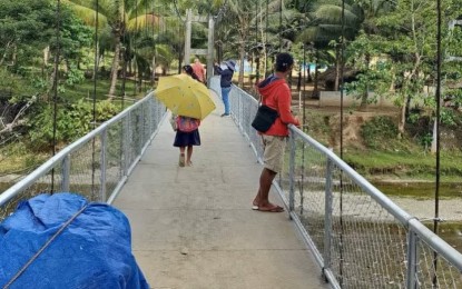 <p><strong>EASY ACCESS</strong>. The new hanging bridge worth PHP5 million in Barangay San Antonio, Oas, Albay is opened to the public on Jan. 24, 2024. The bridge eliminates the need for residents and students to cross the river on foot. <em>(Photo courtesy of Rep. Cabredo)</em></p>