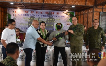 <p><strong>RIGHT PATH.</strong> Major Gen. Alex Rillera (2nd from right), together with other military and local government officials, accepts a high-powered rifle from one of eight rebels who surrendered Monday (Jan. 29, 2024) to the headquarters of the Army’s 57th Infantry Battalion in North Upi, Maguindanao del Norte. The surrenderers consisted of six members of the Dawlah Islamiya Group and two New People’s Army fighters. <em>(Photo courtesy of 6ID)</em></p>