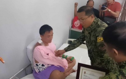 <p><strong>COURAGE.</strong> Philippine National Police (PNP) chief Gen. Benjamin Acorda bestows an award to a police officer injured in an encounter with the criminal group in Samar during his visit to Calbayog City Friday (Feb. 2, 2024). The official reminded policemen to stay away from politics and uphold and protect the Constitution. <em>(PNA photo by Roel Amazona)</em></p>