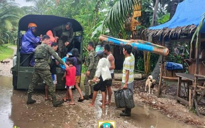 <p><strong>HELPING HAND.</strong> Troops from the Philippine Army's 67th Infantry Battalion carry out rescue operations in Cateel, Davao Oriental on Jan. 31, 2024. The NDRRMC on Monday (Feb. 5) said bad weather caused by the northeast monsoon and the trough of a low pressure area has so far affected over 214,000 families in various parts of Mindanao. <em>(Photo courtesy of the Philippine Army's 67th Infantry Battalion)</em></p>