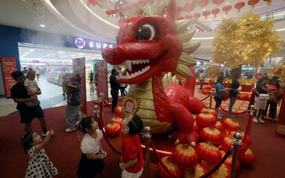 <p><strong>ENTER THE YEAR OF THE DRAGON. </strong>Mallgoers take photos with the Chinese dragon displayed inside a mall in Bacoor, Cavite on Feb. 6, 2024. President Ferdinand R. Marcos Jr. on Saturday (Feb. 10, 2024) expressed optimism that the Year of the Dragon would bring good fortune and prosperity to the Philippines.<em> (PNA photo by Yancy Lim)</em></p>