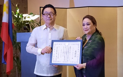 <p><strong>FOOD TIES</strong>. Filipino chef Reggie Aspiras receives the Ambassador's Commendation from Japanese Ambassador to the Philippines Kazuhiko Koshikawa at the latter's residence in Makati City on Friday (Feb. 9, 2024). Aspiras said she intends to continue promoting Japanese and Filipino relations “one dish and one bite at a time.” <em>(PNA photo by Joyce Rocamora)</em></p>