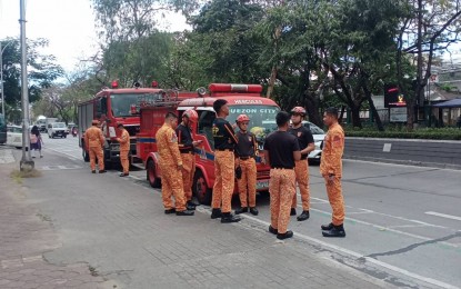 <p><strong>ON ALERT</strong>. Bureau of Fire Protection officers responding to bomb threats are on standby along Visayas Avenue in Diliman, Quezon City on Monday (Feb. 12, 2024). The Department of Environment and Natural Resources and Philippine Information Agency buildings received the threats which turned out to be hoaxes. <em>(PNA photo by Raquel Bonustro)</em></p>
