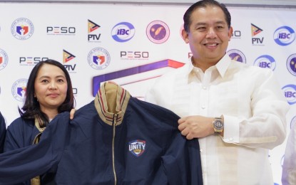 <p><strong>UNITY LEAGUE</strong>. Speaker Martin Romualdez receives a jacket from PTV General Manager Annalisa Puod to mark the launch of Unity League at the Midas Hotel in Pasay City on Monday (Feb. 12, 2024). Unity League is a grassroots tournament for esports that aims to produce potential national esports athletes.<em> (PNA photo by Ben Pulta)</em></p>