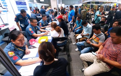 <p><strong>GUNS EXPO.</strong> Gun enthusiasts apply for a License To Own and Possess a Firearm (LTOPF) during the Tactical, Survival and Arms Expo 2024 held at the SMX Convention Center in Davao City on Feb. 8, 2024. A one-stop shop was established at the exhibit area for those who wanted to process the permits. <em>(PNA photo by Robinson Niñal Jr.)</em></p>