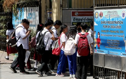 <p><strong>NO QUICK SHIFT.</strong> Students enter the Manuel Araullo High School in Manila in this undated photo. The Department of Education on Wednesday night (April 10, 2024) said the immediate return to the old school calendar would affect the welfare of students and teachers. <em>(PNA file photo)</em></p>