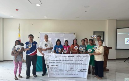 <p><strong>LIVELIHOOD GRANT</strong>. Some members of the tourism workers associations in Bolinao town in Pangasinan who are recipients of the PHP3.1 million grant from the Department of Social Welfare and Development (DSWD) during the turnover ceremony on Monday (Feb. 26,2024) at the Bolinao municipal hall. The grant will be used to buy equipment to boost the workers’ income.<em> (Photo courtesy of Bolinao LGU)</em></p>