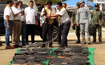 <p><strong>DECOMMISSIONING</strong>. President Ferdinand R. Marcos Jr. witnesses the destruction of surrendered firearms during the "Panabangan Si Kasanyangan" peace offering ceremony in Sumisip, Basilan on Saturday (March 2, 2024). In his speech, Marcos vowed to transform Basilan into a food and fisheries production center. <em>(Photo courtesy of Presidential Photojournalists Association)</em></p>
