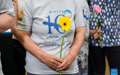 <p><strong>REMEMBRANCE</strong>. People hold flowers at an event marking the 10th year since the disappearance of Malaysian Airlines flight MH370 in Subang Jaya, Selangor state, Malaysia on Sunday (March 3, 2024). The plane was bound for Beijing Capital International Airport in China when it disappeared and has not been found up to now. <em>(Photo by Chong Voon Chung/Xinhua)</em></p>