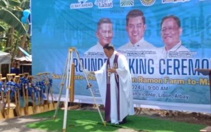 <p><strong>FARM-TO-MARKET ROAD</strong>. A priest blesses the time capsule during the groundbreaking ceremony for a three-kilometer farm-to-market road in Libon, Albay on March 2, 2024. The PHP100-million project will provide convenience to farmers in delivering their agricultural produce to the markets. <em>(Photo courtesy of DAR Bicol)</em></p>