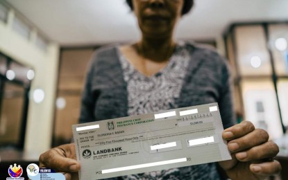 <p style="text-align: left;"><strong>FIRST INSURANCE CLAIM</strong>. Florencia Radan, a wife-beneficiary of a Bantay Dagat volunteer, receives an insurance claim worth PHP55,000 from the Bureau of Fisheries and Aquatic Resources (BFAR) and the Philippine Crop Insurance Corporation (PCIC) in Oas, Albay in this undated photo. The BFAR said on Monday (March 11, 2024) this is the first death benefit claim under the Bantay Dagat Insurance Program. <em>(Photo courtesy of BFAR)</em></p>