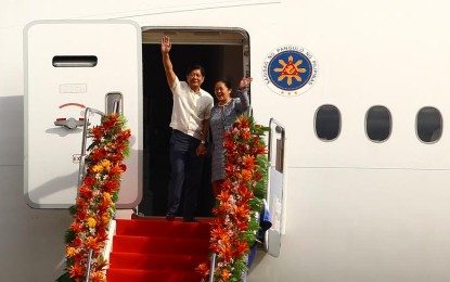 <p><strong>OFF TO WORK.</strong> President Ferdinand R. Marcos Jr. and First Lady Liza Araneta-Marcos wave to well-wishers at Villamor Air Base in Pasay City on March 11, 2024. Anakalusugan party-list Rep. Ray Reyes on Wednesday (April 17) said the 90-percent increase in the country's foreign direct investments proves that President Marcos’ official trips abroad benefit the Philippine economy. <em>(PNA photo by Joan Bondoc)</em></p>