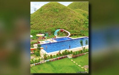 <p><strong>NO CLEARANCE.</strong> The Captain's Peak Garden and Resort built within the Chocolate Hills in Bohol was not issued an Environmental Compliance Certificate. Environment Secretary Antonia Yulo-Loyzaga says in a virtual press briefer on Friday (March 15, 2024) that the owner of the resort faces imprisonment and milions in penalties. <em>(Screengrab from video of Ren the Adventurer)</em></p>