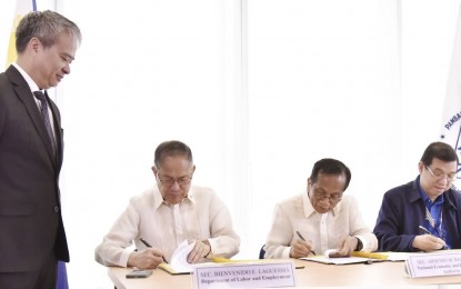 <p><strong>BOOSTING EMPLOYMENT.</strong> (Seated, L-R) Labor Secretary Bienvenido Laguesma, NEDA Secretary Arsenio Balisacan and DTI officer-in-charge Ceferino Rodolfo sign the implementing rules and regulations of Republic Act 11962 or Trabaho Para sa Bayan Act at the NEDA Central Office in Mandaluyong City on Tuesday (March 12, 2024). Laguesma said signing of the IRR shows the commitment of the Marcos administration to a comprehensive and united response in building a strong nation and a healthy economy. <em>(Photo courtesy of DOLE)</em></p>