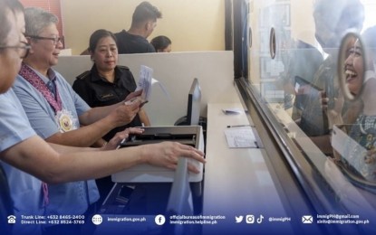 <p><strong>BETTER SERVICE.</strong> Immigration Commissioner Norman Tansingco (left) checks documents of a client at the new BI office in Siargao island on Tuesday (March 12, 2024), The office is expected to provide visa extensions and other essential immigration services to foreigners in the island. <em>(Photo courtesy of BI)</em></p>