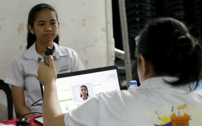 <p><strong>REGISTRATION.</strong> A student is photographed during the 2024 voter education and registration at the University of Santo Tomas in Manila on March 14, 2024. The Commission on Elections (Comelec) implemented its Special Register Anywhere Program (SRAP) as part of efforts to enlist up to three million more voters for next year’s polls.<em> (PNA file photo by Yancy Lim)</em></p>