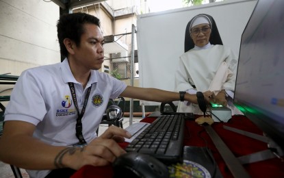 <p><strong>'REGISTER ANYWHERE'. </strong>A nun places her thumb on a scanning device for biometrics data capturing during the voter education and registration fair at the University of Santo Tomas in Manila on March 14, 2024. The Commission on Elections (Comelec) implemented its Special Register Anywhere Program (SRAP) in select areas during the voter registration period for the 2025 midterm polls, which runs from Feb. 12 to Sept. 30 this year. <em>(PNA photo by Yancy Lim)</em></p>