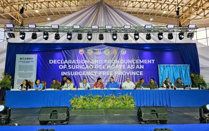 <p><strong>PEACE.</strong> Interior and Local Government Secretary Benjamin Abalos Jr. and Defense Secretary Gilberto Teodoro Jr. (6th and 7th from left) lead the declaration of Surigao del Norte province as insurgency-free on Friday (March 15, 2024). Thirty former rebels also recited oaths of allegiance to the government.<em> (Photo courtesy of PIA-Surigao del Norte)</em></p>