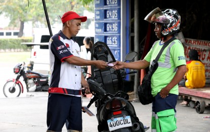 <p><strong>FUEL SUBSIDIES.</strong> A gas station attendant fills up a motorcycle gas tank at a gas station in Intramuros, Manila on March 18, 2024. Manila Rep. Joel Chua recommended on Wednesday (April 17, 2024) the use of the Kadiwa market system in implementing the targeted fuel subsidies for poor and low-income households to cushion the impact of rising oil prices. <em>(PNA photo by Yancy Lim)</em></p>