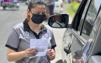 <p><strong>ROAD SAFETY.</strong> A Land Transportation Office-Bicol staff inspects the document of a private vehicle in this undated photo. LTO-Bicol will activate its “Oplan Ligtas Biyahe for Semana Santa 2024” to ensure the safety of motorists, travelers, and commuters during the Holy Week (March 25 to 31) and summer vacation.<em> (Photo courtesy of LTO Bicol)</em></p>