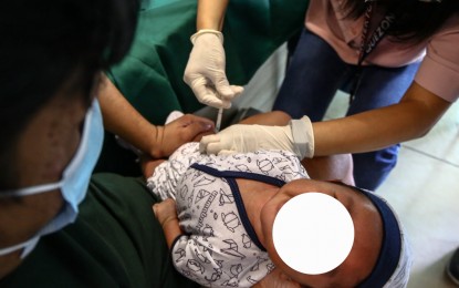 <p><strong>PROTECTION.</strong> A mother brings her child less than a year old for pentavalent vaccination at a health center in Barangay Pinyahan, Quezon City on March 22, 2024. The  vaccine protects against diptheria, tetanus, pertussis, influenza type B and hepatitis B. <em>(PNA photo by Joan Bondoc)</em></p>