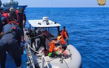 <p><strong>HARASSED.</strong> Six Philippine Navy soldiers and essential cargoes are transferred by a rigid-hull inflatable boat from resupply boat Unaizah May 4 and the Philippine Coast Guard vessel BRP Cabra to BRP Sierra Madre at 11:09 a.m. on Saturday (March 23, 2024). Hours earlier, two China Coast Guard vessels trained their water cannons on Unaizah May 4, inflicting heavy damage. <em>(Photo courtesy of AFP)</em></p>