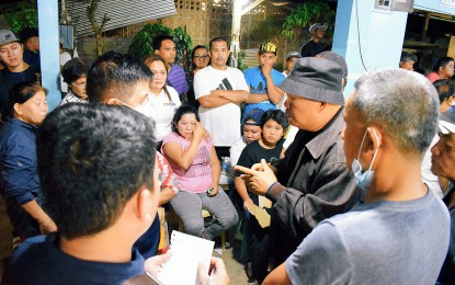 <p><strong>TRAGIC.</strong> Antipas Mayor Cristobal Cadungon (right, in black hat) visits a funeral parlor at the Cotabato town on Monday night (March 25, 2024) to meet with the families of the victims of a road accident that killed 17. All but one of the passengers of a van died after it collided with a dump truck earlier in the day.<em> (Photo courtesy of Antipas LGU)</em></p>
<p><em> </em></p>