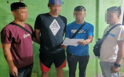 <p><strong>NOWHERE TO RUN</strong>. Alleged kidnapper "Michael" is being read his "Miranda" rights by plainclothes police officers shortly after his arrest in San Pedro City on Tuesday (March 26, 2024). He was Calabarzon's second "most wanted" person.<em> (Photo courtesy of Laguna Provincial Police Office)</em></p>