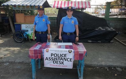 <p><strong>HEALTH PROTOCOLS.</strong> Members of the Philippine National Police (PNP) placed an assistance desk in front of the Aglipayan church in Sibalom, Antique, on Thursday (March 28, 2024). Antique Provincial Disaster Risk Reduction and Management Office (PDRRMO) head Broderick Train said in an interview that assistance desks in churches, terminals, and other convergence areas are available until March 31 to ensure public safety. (<em>PNA photo by Annabel Consuelo J. Petinglay)</em></p>