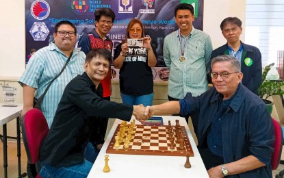 <p><strong>MIND PLAY.</strong> Grandmasters Eugene Torre (seated, right) and Rogelio "Joey" Antonio Jr. shake hands during the Philippine Technological Council World Engineering Day at Koten Enterprise in Pasay City on March 24, 2024. Torre, Asia's first Grandmaster, will lead a simultaneous exhibition in Tarlac on April 9. <em>(Contributed photo)</em></p>