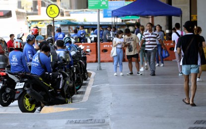 <p><strong>MOTORCYCLE TAXIS.</strong> Motorcycle taxi drivers await passengers outside the Parañaque Integrated Terminal Exchange on April 1, 2024. The Land Transportation Franchising and Regulatory Board on Monday (April 8, 2024) said the 8,000 slots for the expansion of the MC taxi study will be awarded outside the National Capital Region following clamor from transport groups so as not to further worsen Metro Manila’s traffic. <em>(PNA photo by Yancy Lim)</em></p>