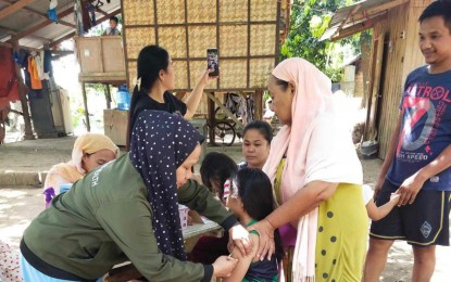 <p><strong>IMMUNIZED.</strong> A child in Pagalungan, Maguindanao del Sur, gets an anti-measles shot from a village health worker as the Ministry of Health in the Bangsamoro Autonomous Region in Muslim Mindanao starts massive vaccination against measles-rubella on Monday (April 1, 2024). BARMM seeks to immunize about 1.3 million children across the region aged nine months to below 10 years old. <em>(Photos courtesy of Pagalungan Rural Health Unit)</em></p>