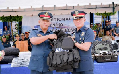 <p><strong>TURNOVER</strong>. Lt. Col. Marcial Yanguas (left), deputy director for administration of the Negros Oriental Police Provincial Office, hands over tactical vests to Capt. Mark Millan, police chief of Tayasan town, at Camp Francisco Fernandez Jr. in Sibulan town on Monday (April 1, 2024). The NOPPO also got night vision devices, crime scene kits and DSAR assault rifles. <em>(Contributed photo)</em></p>