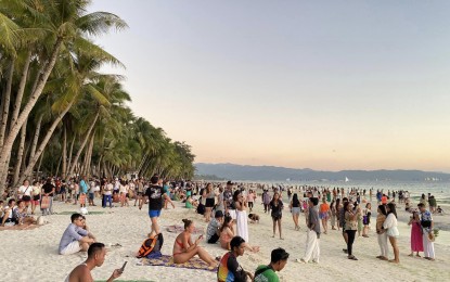 <p><strong>TOURISTS AT THE BEACH</strong>. Thousands of tourists flock to Boracay Island in Malay, Aklan during the Holy Week. Malay chief tourism operations officer Felix G. delos Santos Jr., in an interview on Monday (April 1, 2024), said they are ready for the influx of tourists this April and May.<em> (Photo courtesy of Kimberly Pineda)</em></p>