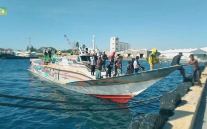 <p><strong>BUSTED.</strong> Navy personnel escort crew members of a motorized banca intercepted off Barangay Batulaki, Glan, Sarangani on March 30, 2024. The boat was caught carrying 1,070 master cases of smuggled cigarettes worth PHP21.4 million. <em>(Photo courtesy of Naval Forces Eastern Mindanao)</em></p>