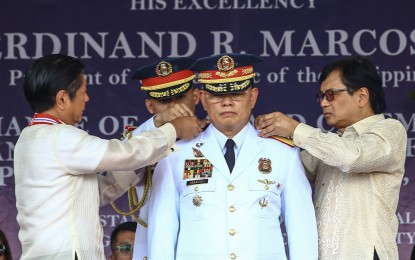 <p><strong>NEW CHIEF</strong>. President Ferdinand R. Marcos Jr. (left) installs Gen. Rommel Francisco Marbil as the 30th chief of the Philippine National Police, assisted by Interior and Local Government Secretary Benhur Abalos (right), at Camp Crame in Quezon City on Monday (April 1, 2024). Marbil replaces Gen. Benjamin Acorda Jr. <em>(PNA photo by Joan Bondoc)</em></p>