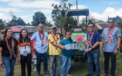 <p><strong>HELP FROM GOV'T.</strong> Department of Agrarian Reform (DAR) Bicol Regional Director Reuben Theodore Sindac (sixth from left) pose for a photo opportunity with recipients of a tractor worth PHP1.85 million during the turnover ceremony on March 21, 2024. The Department of Agrarian Reform (DAR) continues to assist different agrarian reform beneficiary organizations in Bicol to enhance crop productivity, reduce production costs and improve incomes.<em> (Photo courtesy of DAR Bicol)</em></p>