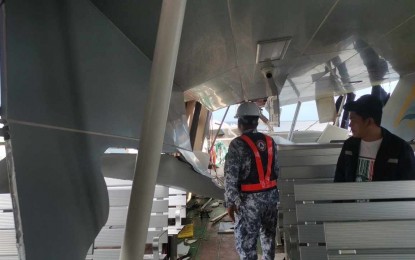 <p><strong>DAMAGE INSPECTION.</strong> Personnel of the Philippine Coast Guard (PCG) inspect the damage on MV Fastcat M19 following its collision with Barge Krizza Rica in waters two nautical miles southeast of Barangay San Agapito, Isla Verde in Batangas on Wednesday (April 3, 2024). The PCG said one passenger of MV Fastcat M19 was injured and sent to a hospital while the rest safely disembarked in Calapan, Oriental Mindoro. <em>(Photo courtesy of PCG)</em></p>