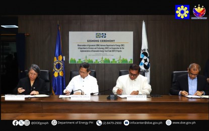 <p><strong>RE PARTNERSHIP</strong>. Energy Secretary Raphael Lotilla (2nd from left) and Science and Technology Secretary Renato Solidum Jr. (3rd from left) sign a memorandum of agreement (MOA) at Department of Energy (DOE) office in Bonifacio Global City, Taguig City on Wednesday (April 3, 2024). The MOA forged a partnership between the DOE and the Department of Science and Technology for research and development in the renewable energy (RE) sector using the RE Trust Fund. <em>(Courtesy of DOE)</em></p>