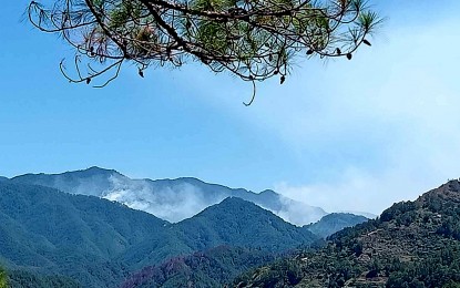 <p><strong>FIRE ALERT</strong>. Smoke is seen from Mt. Kalawitan in Nabua, Sabangan, Mountain Province as fire razes a portion of the mountain on Friday (April 5, 2024). Warden Taltala, municipal tourism officer, said the fire started early in the day. (<em>Contributed photo/Jimmy Ceralde</em>)</p>