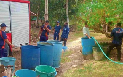 <p><strong>WATER RATIONING.</strong> The Bureau of Fire Protection fills large plastic buckets as part of water rationing activities in drought-stricken villages in Kidapawan City in Cotabato Province on April 5, 2024. Senator Francis Tolentino on Monday (April 8) hoped that the United States Navy could assist the Philippine government in its cloud seeding operations to help minimize the effects of the El Niño phenomenon. <em>(Photo courtesy of Kidapawan CIO)</em></p>