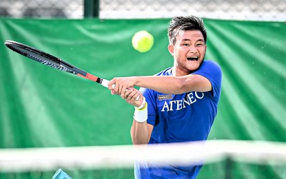 <p><strong>POWER.</strong> Ateneo's JD Velez hits a backhand return against University of Santo Tomas in the opener of the UAAP Season 86 men's tennis best-of-three championship at the Felicisimo Ampon Tennis Center inside the Rizal Memorial Sports Complex in Manila on April 3, 2024. Ateneo and defending champion UST will dispute the title on Sunday (April 7) in the same venue.<em> (UAAP photo)</em></p>