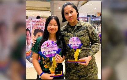<p><strong>CHAMP. </strong>​Champion Ruelle Canino (left) poses with ​Woman Grandmaster Janelle Mae Frayna, who finished ​​third, during the awarding ceremony of the Philippine National Women’s Chess Championship​ in Malolos, Bulacan on March 24, 2024. C​anino will lead the Far Eastern University team in the Bangkok Open scheduled April 13-21 in Thailand. <em>(Contributed photo) </em></p>