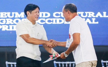 <p><strong>AGRARIAN REFORM.</strong> President Ferdinand R. Marcos Jr. distributes land titles to 2,797 agrarian reform beneficiaries in Negros Oriental on Monday (April 8, 2024). Aside from the titles, the President also handed out some PHP69 million worth of agricultural assistance to the beneficiaries. <em>(Presidential Communications Office)</em></p>