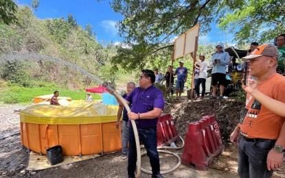 <p><strong>SIPHON TANKS.</strong> Metro Cebu Water District chair Jose Daluz III tests the pressure of a mobile siphon tank deployed to two hinterland villages in Cebu City. MCWD spokesperson Minerva Gerodias on Monday (April 8, 2024) said the deployment of the two tanks to Cambinocot and Bonbon villages could cushion the impact of the dry spell by providing potable water to upland residents. <em>(Photo courtesy of MCWD)</em></p>