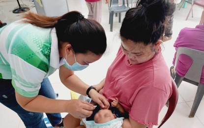 <p><strong>VACCINATION</strong>. A health worker from Ilocos Norte provides oral polio vaccine to an infant in this undated photo. The Provincial Health Office is calling on expectant mothers and children to get vaccinated against pertussis. <em>(Photo courtesy of DOH-Ilocos Center for Health Development)</em></p>
