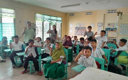 <p><strong>MADRASAH.</strong> Dr. Eleanore Dagala, Department of Education (DepEd) Antique supervisor for Aralin Panlipunan of which the Madrasah Education belongs (standing center) with learners of the Gov. Santos Capadocia Memorial School in San Jose de Buenavista doing their DepEd Region VI mantra Home of the Champions (C-sign) in this undated photo. Dagala said in an interview Wednesday (April 10, 2024) that as part of the inclusive program for Muslim learners, there is a plan to open the Madrasa Education for Muslim secondary learners this school year 2024-2025. <em>(Photo courtesy of DepEd Antique)</em></p>