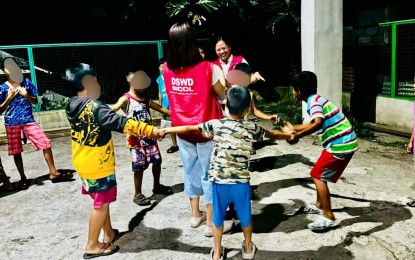 <p><strong>GOV'T INTERVENTIONS.</strong> Department of Social Welfare and Development (DSWD) personnel play with children affected by the recent clash between government troops and the New People's Army (NPA), in Barangay Villa Paz, Jovellar, Albay on Wednesday (April 10, 2024). Aside from essential supplies, such as family food packs, and hygiene and sleeping kits, the DSWD-Bicol also provided psychological support services to the affected families. <em>(Photo courtesy of DSWD-5)</em></p>